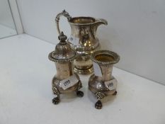 A pair of silver Asprey and Co Ltd peppers with gadrooned rim and lion feet. One lidded. Hallmarked