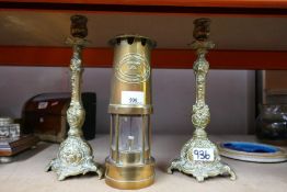 Brass miners lamp 'E Thomas and Williams' Cambrian 82251, and a pair of brass candlesticks