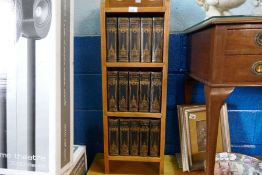 A set of fifteen Charles Dickens books in oak pillar case