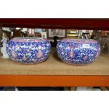 A pair of oriental blue ground floral decorated vases; character marks to base