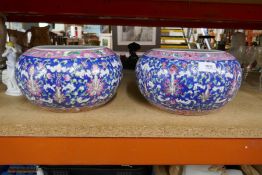 A pair of oriental blue ground floral decorated vases; character marks to base