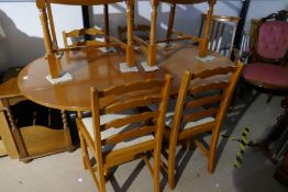 A modern oval dining table with a set of six matching chairs