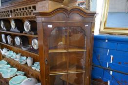 A reproduction burr walnut standing corner cupboard and a cane chair