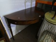 An antique mahogany bow fronted occasional table