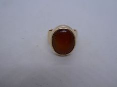 9ct yellow gold gents signet ring, with large oval orange hardstone, marked 9ct, 12.7g approx, size