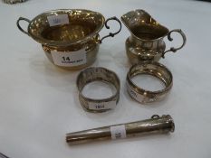 A Silver sugar bowl and cream ring and two silver napkin rings. Hallmarked to include Chester early