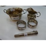 A Silver sugar bowl and cream ring and two silver napkin rings. Hallmarked to include Chester early