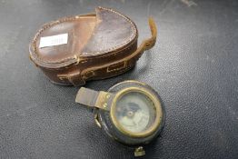 A WWI period pocket compass in original leather case, dated 1917