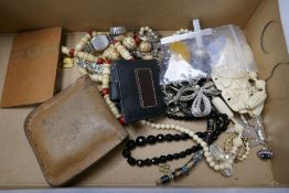 A box of various costume jewellery to include carved bead necklaces, and a silver Celtic brooch inse