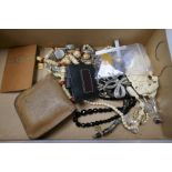 A box of various costume jewellery to include carved bead necklaces, and a silver Celtic brooch inse