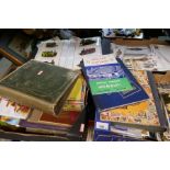 Four small boxes containing postcard albums, maps, cigarette albums, military themed postcards, etc