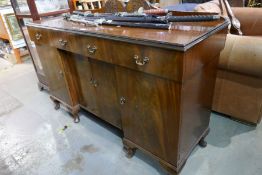 A reproduction mahogany sideboard having raised back