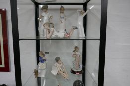 Six Nao figurines and one Lladro example