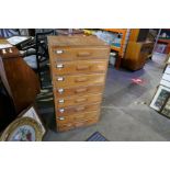 A vintage oak office chest having eight drawers