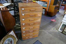 A vintage oak office chest having eight drawers