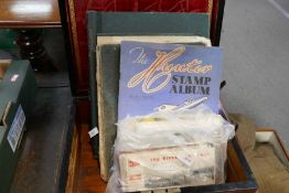 An antique rosewood box containing postcards, stamps and similar