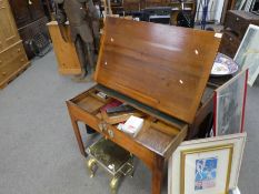 A Georgian oak architects table with extending front and various architects tools