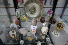 Two shelves of decorated eggs including Humpty Dumpty
