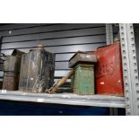 Shelf of various vintage oil cans, tins, oil tunnels & pumps