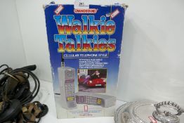 A boxed set of 80s style phones walkie talkies