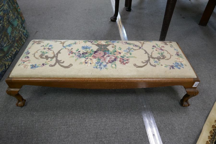 A Victorian duet  foot stool  with tapestry top on claw and ball supports