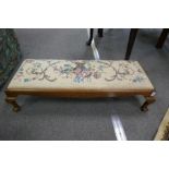 A Victorian duet  foot stool  with tapestry top on claw and ball supports