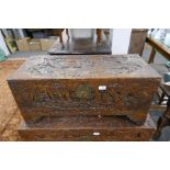 A camphor wood blanket box heavily carved with oriental decoration depicting ships and birds