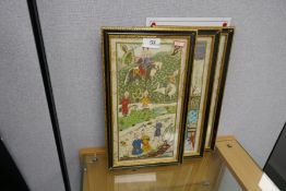 Three decorative framed and glazed Indian silk panels depicting figures, 32 x 17cm approx