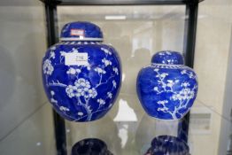 Two blue and white Chinese ginger jars, complete with original lids and a pair of decorative vases