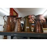 A selection of various vintage brass and copper water jugs some with maker's stamps and logos to the