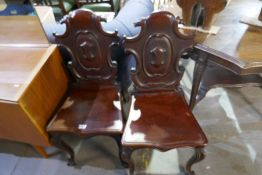 A pair of Victorian shield back mahogany side chairs on cabriole supports