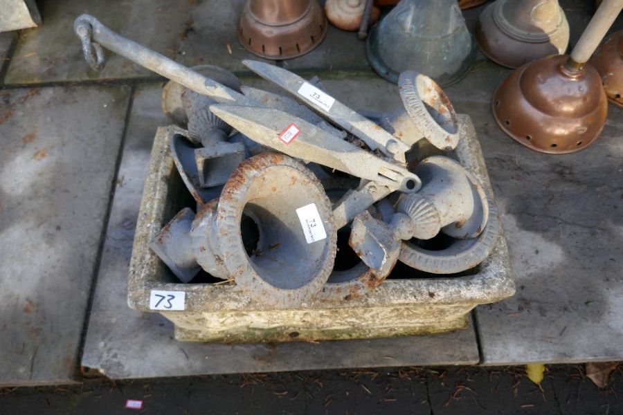 Rectangular stone effect garden planter containing quantity of wrought metal painted miniature urns