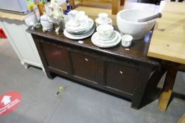 An antique oak coffer with panelled front and carved decoration, 113cm