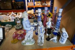 Four Jersey pottery lamps and a collection of continental figurines including Lladro, Nao etc