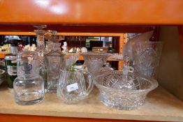 A large selection of cut glass comprising decanters, cake stands, etc