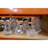 A large selection of cut glass comprising decanters, cake stands, etc