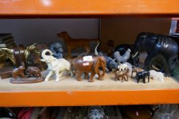 Various mostly carved animal figurines including elephants, baboon etc