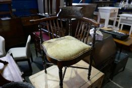 A Victorian carved mahogany corner chair with horsehair seat on turned supports