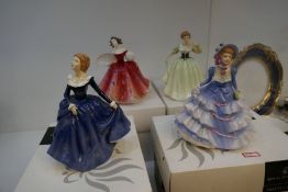 A selection of four Royal Doulton figures in fine dress: Fragrance, Hannah, First Waltz & Lily