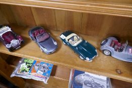 Three 1/18th scale model vehicles by Burago and another by Norev