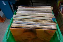 Two crates and a green carry case of various Folk and Pop LPs