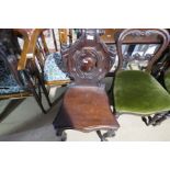 A pair of Victorian carved back hall chairs, with cabriole legs