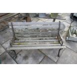 Vintage weathered teak garden bench on cart iron ends