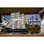 A large wooden model ship on stand with 2 rows of guns, 90cm and another on stand along with small g