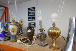 A selection of table lamps made of various materials including china, brass and possibly bronze