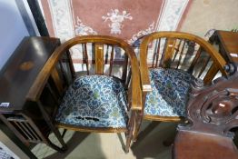 A pair of Edwardian mahogany inlaid spindle back tub chairs and inlaid mahogany drop back table and