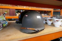 A metal army helmet plus Harley Davidson crash helmet