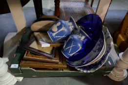 A box of mixed items to include blue and white chargers, picture frames, barometer, etc