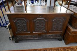 An antique oak mule chest with later carved panels, 145cm x 53cm