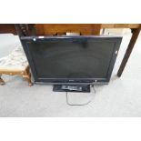 A Sony Bravia flat screen TV with remote